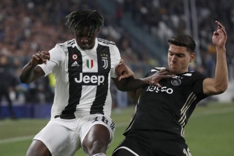 Juventus' Moise Kean, left, and Ajax's Lisandro Magallan fight for the ball during the Champions League quarter final, second leg soccer match between Juventus and Ajax, at the Allianz stadium in Turin, Italy, Tuesday, April 16, 2019. (AP Photo/Antonio Calanni)