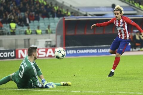 Atletico Madrid's Filipe Luis, right, in an unsuccessful attempt to score past Qarabag's goalkeeper Ibrahim Sehic during the Champions League, group C, soccer match between Qarabag FK and Atletico Madrid at the Baku Oliympiy stadium in Baku, Azerbaijan, Wednesday, Oct. 18, 2017. (AP Photo/Aziz Karimov)