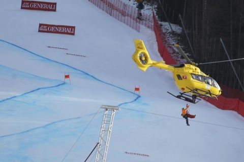 Slovenia's Klemen Kosi not seen in the picture is carried by an helicopter to be transferred to an hospital after crashing during a ski World Cup Men's Downhill in Bormio, Italy, Friday, Dec.28, 2018. (AP Photo/Marco Trovati)