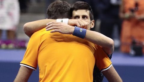 Novak Djokovic, of Serbia, right, hugs Juan Martin del Potro, of Argentina, after Djokovic defeated del Potro in the men's final of the U.S. Open tennis tournament, Sunday, Sept. 9, 2018, in New York. (AP Photo/Julie Jacobson)