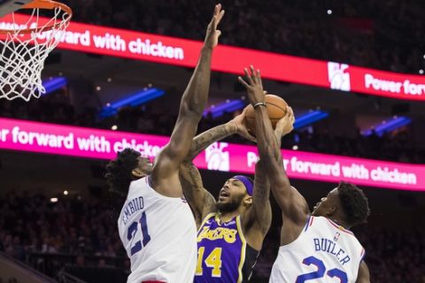 Los Angeles Lakers' Brandon Ingram, center, goes up for the shot against Philadelphia 76ers' Joel Embiid, left, of Cameroon, and Jimmy Butler, right, during the first half of an NBA basketball game, Sunday, Feb. 10, 2019, in Philadelphia. (AP Photo/Chris Szagola)