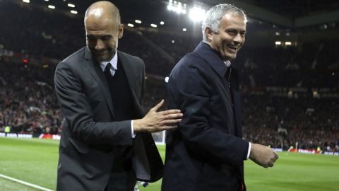 Manchester City's manager Pep Guardiola, left, and Manchester United's manager Jose Mourinho smile ahead of the English League Cup soccer match between Manchester United and Manchester City at Old Trafford stadium in Manchester, Wednesday, Oct. 26, 2016. (AP Photo/Dave Thompson)