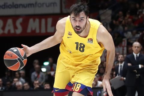 Barcelona's Pierre Oriola, left, challenges for the ball with Olimpia Milan's Luis Scola during the Euro League basketball match between Olimpia Milan and FC Barcelona Lassa, in Milan, Italy, Friday, Nov. 1, 2019. (AP Photo/Antonio Calanni)