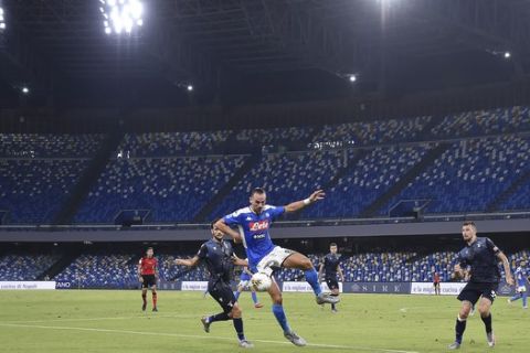 Players compete in an empty San Paolo stadium during a Serie A soccer match between Napoli and Lazio in Naples, Italy on Saturday, Aug. 1, 2020. (Cafaro/LaPresse via AP)