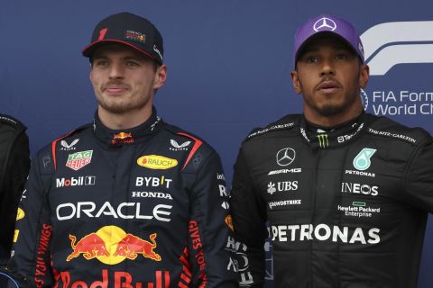 The top 3 fastest qualifiers, Mercedes driver George Russell of Britain, left, Red Bull driver Max Verstappen of Netherlands and Mercedes driver Lewis Hamilton of Britain, right, pose for a photo ahead of the Australian Formula One Grand Prix at Albert Park in Melbourne, Saturday, April 1, 2023. Verstappen qualified fasted, Russell second and Hamilton is 3rd. (AP Photo/Asanka Brendon Ratnayake)