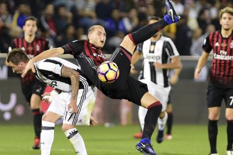 AC Milan's Gabriel Paletta goes for the ball during the Italian Super Cup soccer match between Juventus and AC Milan, at the Al Sadd Sports Club in Doha, Qatar, Friday, Dec. 23, 2016. (AP Photo/Alexandra Panagiotidou)