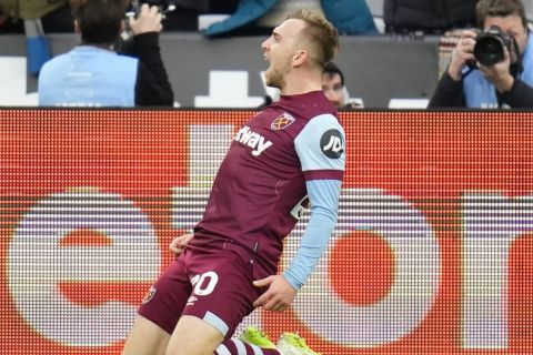 West Ham's Jarrod Bowen celebrates after scoring his side's opening goal during the English Premier League soccer match between West Ham United and Manchester United at the London stadium in London, Saturday, Dec. 23, 2023. (AP Photo/Kirsty Wigglesworth)