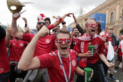 Denmark soccer fans celebrate their team's opening goal by Denmark's Christian Eriksen while they watching a huge screen during the group C match between Denmark and Australia at the 2018 soccer World Cup in St. Petersburg, Russia, Thursday, June 21, 2018. (AP Photo/Lee Jin-man)