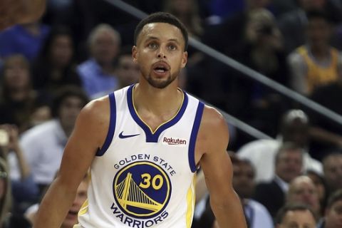 Golden State Warriors' Stephen Curry looks after shooting against the Oklahoma City Thunder during the second half of an NBA basketball game Tuesday, Oct. 16, 2018, in Oakland, Calif. (AP Photo/Ben Margot)