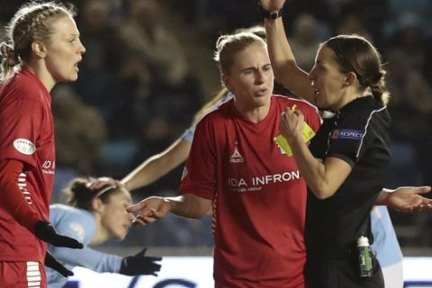 Linkoping's Lisa Lantz left is shown a red card by referee Stephanie Frappart during the Women's Champions League, quarter final soccer match between Manchester City and Linkoping, at the City Football Academy, in Manchester, England, Wednesday, March 21, 2018. (Martin Rickett/PA via AP)