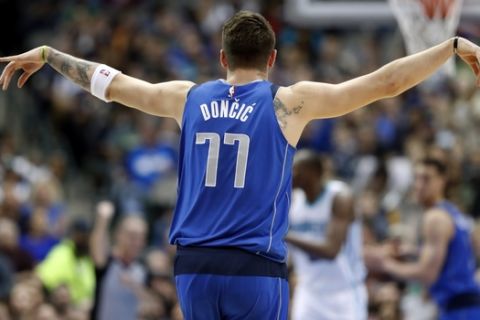 Dallas Mavericks forward Luka Doncic (77) celebrates his assist for a basket against the Charlotte Hornets in the first half of an NBA basketball game in Dallas, Wednesday, Feb. 6, 2019. (AP Photo/Tony Gutierrez)
