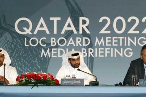 FILE - In this Wednesday, Feb. 25, 2015, file photo, Nasser Al Khater Qatar 2022 Local Organizing Committee Deputy CEO, left, Hassan Al Thawadi, head of the Qatar 2022 World Cup organizing committee, center, and FIFA Secretary General Jerome Valcke give a press conference, in Doha. Qatar is keeping quiet about the American and Swiss raids that have rocked footballs world governing body FIFA and thrown a new unwelcome spotlight on the tiny Gulf nations hosting of the 2022 World Cup.  (AP Photo/Osama Faisal, File)