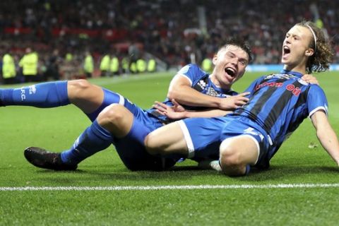 Rochdale's Luke Matheson, right, celebrates scoring his side's first goal of the game during the English League Cup, Third Round soccer match between Manchester United and Rochdale at Old Trafford, Manchester, England, Wednesday, Sept. 25, 2019. (Richard Sellers/PA via AP)