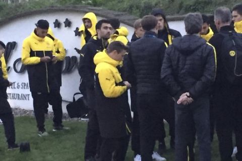 Head coach Thomas Tuchel, center, is surrouned by players after the bus of Borussia Dortmund was damaged after an explosion before the Champions League quarterfinal soccer match against AS Monaco in Dortmund, western Germany, Tuesday, April 11, 2017. (Carsten Linhoff/dpa via AP)