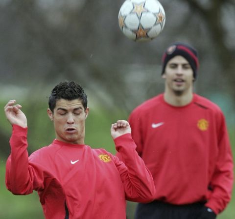 Manchester United's Cristiano Ronaldo, left, and Gerard Pique, right, train at the Carrington training ground ahead of their Champions League Group F soccer match against Sporting Lisbon, Manchester, England, Monday, Nov. 26, 2007. Manchester play Lisbon at Old Trafford Stadium on Tuesday, Nov. 27. (AP Photo/Paul Thomas)