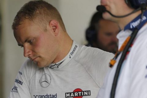 Williamns driver Valtteri Bottas, of Finland, looks at the results inside his team's pit during a free practice for the Formula One Brazilian Grand Prix at the Interlagos race track in Sao Paulo, Brazil, Friday, Nov. 13, 2015. The race is on Sunday, the penultimate round of the season. (AP Photo/Silvia Izquierdo)