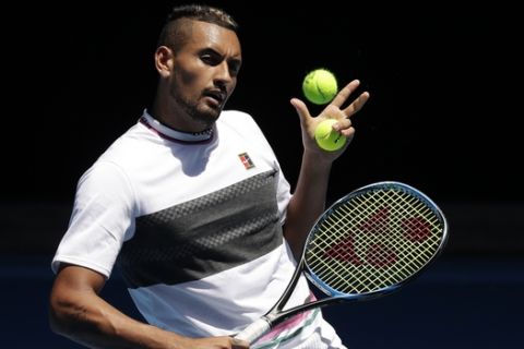 Australia's Nick Kyrgios hits a backhand volley during a practice session at the Australian Open tennis championships in Melbourne, Australia, Sunday, Jan. 13, 2019. (AP Photo/Kin Cheung)