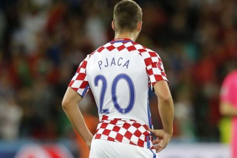 Croatia's Marko Pjaca stands on the pitch at the end of the Euro 2016 round of 16 soccer match between Croatia and Portugal at the Bollaert stadium in Lens, France, Saturday, June 25, 2016. (AP Photo/ Michel Spingler)