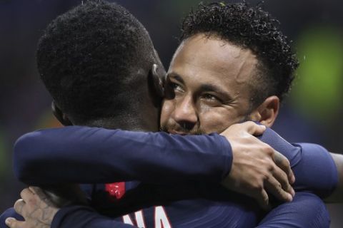 PSG's Neymar, right, celebrates twith teammate PSG's Idrissa Gueye after he scores the opening goal of the game during the French League 1 soccer match between Lyon and Paris SG, at the Stade de Lyon in Decines, outside Lyon, France, Sunday, Sept. 22, 2019. (AP Photo/Laurent Cipriani)