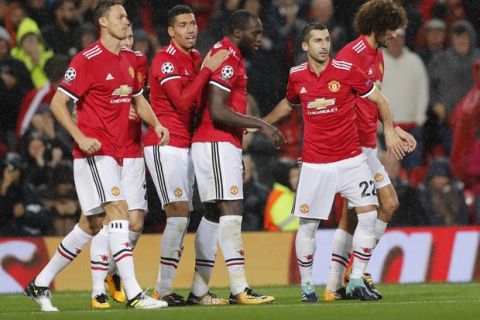 Manchester United's Romelu Lukaku, center, celebrates his goal with his teammates during the Champions League group A soccer match between Manchester United and Basel, at the Old Trafford stadium in Manchester, Tuesday, Sept. 12, 2017. (AP Photo/Frank Augstein)