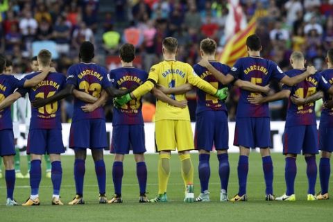 FILE - In this Sunday, Aug. 20, 2017 file photo, Barcelona players stand for a minute of silence for the victims of the van attacks before a La Liga soccer match between Barcelona and Betis at the Camp Nou stadium in Barcelona, Spain. (AP Photo/Manu Fernandez, File)