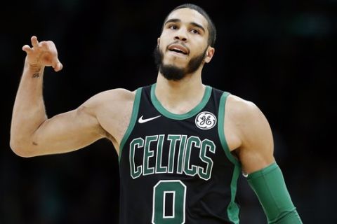 Boston Celtics' Jayson Tatum reacts after making a three-point basket during the second half of an NBA basketball game against the Charlotte Hornets in Boston, Sunday, Dec. 22, 2019. (AP Photo/Michael Dwyer)