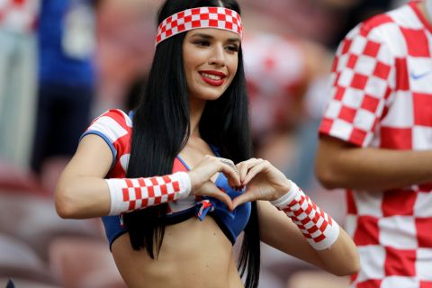 A fan of Croatia joins her fingers in the shape of a heart prior to the final match between France and Croatia at the 2018 soccer World Cup in the Luzhniki Stadium in Moscow, Russia, Sunday, July 15, 2018. (AP Photo/Natacha Pisarenko)