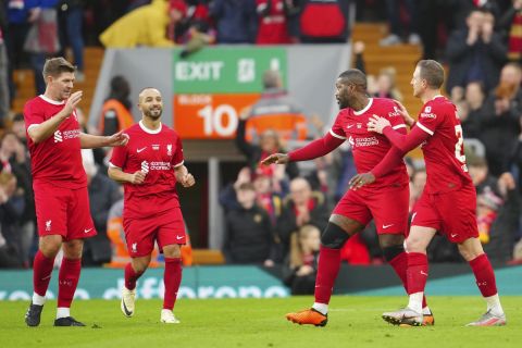 Liverpool Legends' Djibril Cisse, second right, celebrates with Steven Gerrard, left after scoring his sides second goal during an exhibition soccer match between Liverpool Legends and Ajax Legends at Anfield Stadium, Liverpool, England, Saturday March 23, 2024. (AP Photo/Jon Super)