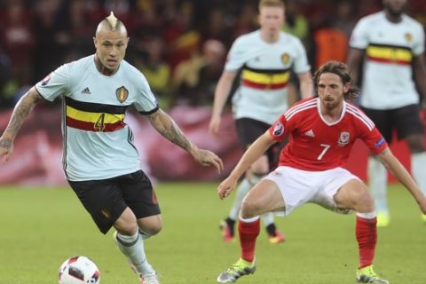 Belgium's Radja Nainggolan, left, vie for the ball with Wales' Joe Allen during the Euro 2016 quarterfinal soccer match between Wales and Belgium, at the Pierre Mauroy stadium in Villeneuve dAscq, near Lille, France, Friday, July 1, 2016. (AP Photo/Petr David Josek)