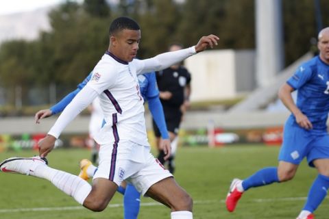 England's Mason Greenwood takes a shot during the UEFA Nations League soccer match between Iceland and England in Reykjavik, Iceland, Saturday, Sept. 5, 2020. England players Phil Foden and Mason Greenwood have been dropped for Tuesday's game against Denmark after breaching coronavirus rules in Iceland. They will return to England from Reykjavik rather than traveling to Copenhagen on Monday Sept. 7, 2020, after social media video was published in Iceland purporting to show the players meeting women from outside the team bubble. (AP Photo/Brynjar Gunnarson)