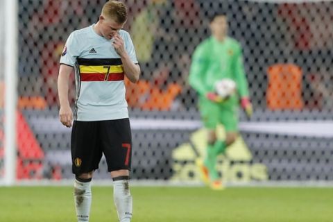 Belgium's Kevin De Bruyne touches his nose after Wales scored their third goal during the Euro 2016 quarterfinal soccer match between Wales and Belgium, at the Pierre Mauroy stadium in Villeneuve d'Ascq, near Lille, France, Friday, July 1, 2016. (AP Photo/Frank Augstein)