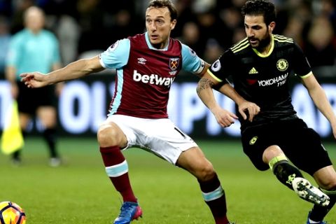 West Ham's Mark Noble, left, and Chelsea's Cesc Fabregas contest for the ball during the English Premier League soccer match between West Ham and Chelsea at London Stadium, Monday, March 6, 2017. (AP Photo/Kirsty Wigglesworth)