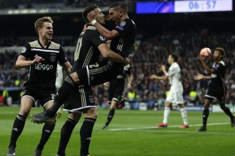 Ajax's Hakim Ziyech, right, celebrates scoring the opening goal during the Champions League soccer match between Real Madrid and Ajax at the Santiago Bernabeu stadium in Madrid, Spain, Tuesday, March 5, 2019. (AP Photo/Manu Fernandez)