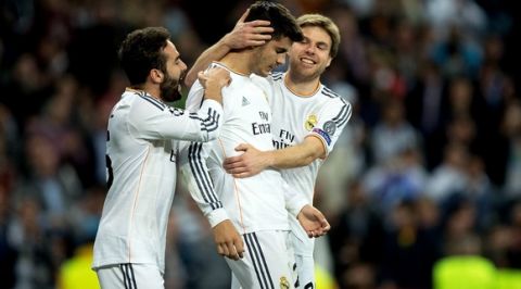 MADRID, SPAIN - MARCH 18:  Alvaro Morata (C) of Real Madrid is congratulated by teammates after scoring his team's third goal during the UEFA Champions League Round of 16, second leg match between Real Madrid and FC Schalke 04 at Estadio Santiago Bernabeu on March 18, 2014 in Madrid, Spain.  (Photo by Gonzalo Arroyo Moreno/Getty Images)