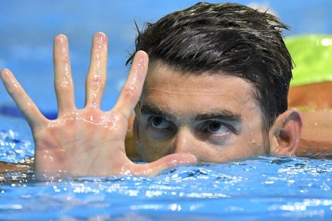 Michael Phelps gestures after winning the men's 200-meter butterfly at the U.S. Olympic swimming trials, Wednesday, June 29, 2016, in Omaha, Neb. (AP Photo/Mark J. Terrill) 
