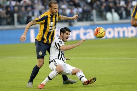 Juventus' Alvaro Morata challenges for the ball with Verona's Evangelos Moras during a Serie A soccer match between Juventus and Verona at the Juventus stadium, in Turin, Italy, Wednesday, Jan. 6, 2016. (AP Photo/ Massimo Pinca)