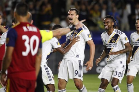 LA Galaxy's Zlatan Ibrahimovic, center, of Sweden, celebrates his goal with teammates during the second half of an MLS soccer match against the Real Salt Lake Saturday, June 9, 2018, in Carson, Calif. The Galaxy won 3-0. (AP Photo/Jae C. Hong)