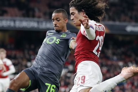 Sporting's Bruno Gaspar, left, and Arsenal's Matteo Guendouzi challenge for the ball during the Europa League group E soccer match between Arsenal and Sporting CP at Emirates stadium in London, England, Thursday, Nov. 8, 2018. (AP Photo/Frank Augstein)