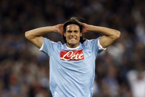 Napoli's Edinson Cavani reacts after missing a goal opportunity against Udinese during their Italian Serie A soccer match at the San Paolo stadium in Naples in this April 17, 2011 file photograph. Napoli's hopes of wrapping up the third automatic Champions League slot in Serie A were hit when top striker Cavani was banned on May 10, 2011 for the last two matches of the campaign. REUTERS/Giampiero Sposito/Files (ITALY - Tags: SPORT SOCCER)