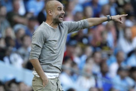 Manchester City's head coach Pep Guardiola gestures during the English Premier League soccer match between Manchester City and Watford at Etihad stadium in Manchester, England, Saturday, Sept. 21, 2019. (AP Photo/Rui Vieira)