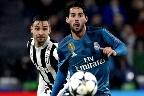 Real Madrid's Isco, right, and Juventus' Rodrigo Bentancur challenge for the ball during the Champions League, round of 8, first-leg soccer match between Juventus and Real Madrid at the Allianz stadium in Turin, Italy, Tuesday, April 3, 2018. (AP Photo/Luca Bruno)