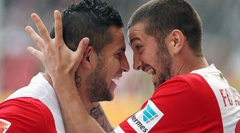 Augsburg's Argentinian striker Raul Bobadilla (L) celebrates scoring the 0-1 goal with Augsburg's striker Sascha Moelders during the German first division Bundesliga football match Eintracht Frankfurt vs FC Augsburg in Frankfurt, centralGermany, on September 14, 2014.  AFP PHOTO / DANIEL ROLAND

DFL RULES TO LIMIT THE ONLINE USAGE DURING MATCH TIME TO 15 PICTURES PER MATCH. FOR FURTHER QUERIES PLEASE CONTACT DFL DIRECTLY AT + 49 69 650050.        (Photo credit should read DANIEL ROLAND/AFP/Getty Images)