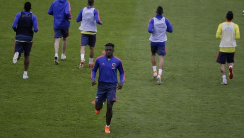 Colombia's soccer player Duvan Zapata, center, warms up during a training session of the national soccer team in Bogota, Colombia, Thursday, June 6, 2019. Colombia will play a friendly match against Peru on June 9. (AP Photo/Fernando Vergara)