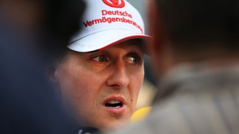Mercedes driver Michael Schumacher of Germany talks to reporters after he failed to finish in the Indian Formula One Grand Prix at the Buddh International Circuit in Noida, on the outskirts of New Delhi, India, Sunday, Oct. 28, 2012. (AP Photo/Manish Swarup)