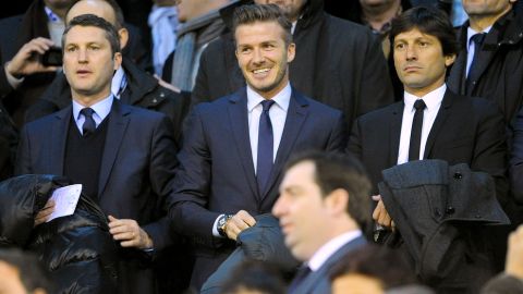 PSG's British forward David Beckham (C) smiles as he attends the UEFA Champions League round of 16 first leg football match Valencia CF vs Paris Saint Germain at the Mestalla stadium in Valencia on February 12, 2013.   AFP PHOTO/ JOSEP LAGO        (Photo credit should read JOSEP LAGO/AFP/Getty Images)