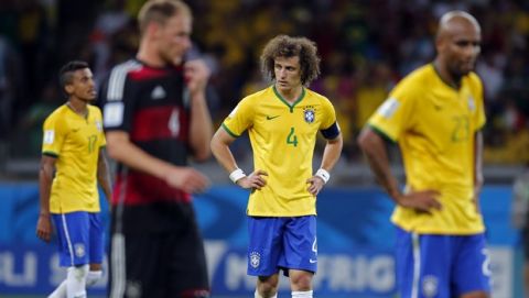 Brazil's David Luiz, center, looks disappointed after Germany scored their sixth goal during the World Cup semifinal soccer match between Brazil and Germany at the Mineirao Stadium in Belo Horizonte, Brazil, Tuesday, July 8, 2014. (AP Photo/Frank Augstein)