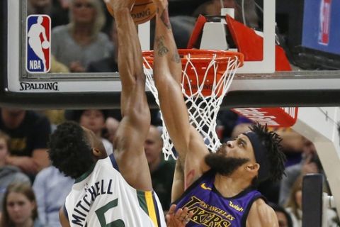 Utah Jazz guard Donovan Mitchell (45) dunks on Los Angeles Lakers center JaVale McGee (7) during the first half of an NBA basketball game Friday, Jan. 11, 2019, in Salt Lake City. (AP Photo/Rick Bowmer)