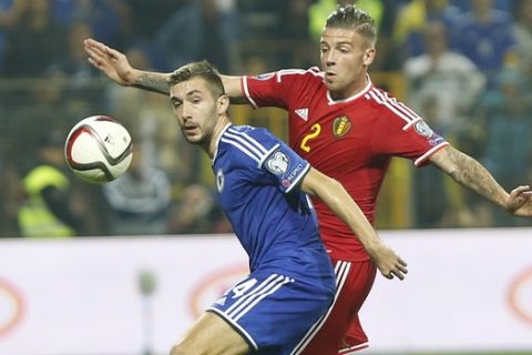 Bosnia's Tino Susic, left, fights for the ball with Toby Alderweireld of Belgium during the Euro 2016 Group B soccer qualifying match between Bosnia and Belgium at Stadium Bilino Polje in Zenica, Bosnia, Monday, Oct. 13, 2014. (AP Photo/Amel Emric)