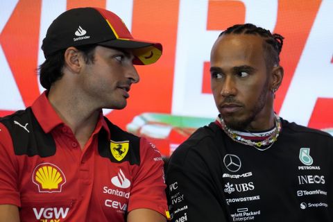 Ferrari driver Carlos Sainz of Spain, left, talks to Mercedes driver Lewis Hamilton of Britain during a press conference at the Baku circuit, in Baku, Azerbaijan, Thursday, April 27, 2022. The Formula One Grand Prix will be held on Sunday April 30, 2023. (AP Photo/Sergei Grits)