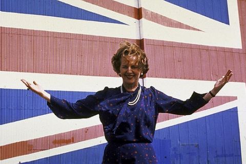 British Prime Minister Margaret Thatcher before stands in  front of a hangar door painted over with a Union Jack (British national flag) at Hovercraft plant on the last day of the Conservative Party campaign in the Isle of Wight, 1983.  (Photo by Peter Jordan//Time Life Pictures/Getty Images)